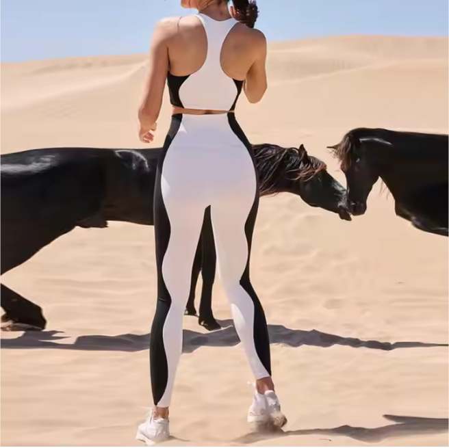 Elevate your workout look with the Black & White Matching Sports Set – Bra & Yoga Leggings. This elegant two-tone design combines style, comfort, and performance in one seamless outfit. The supportive sports bra ensures a secure fit, while the high-waist leggings sculpt your figure and stay in place through every stretch and squat. Crafted from soft, breathable, and quick-dry fabric, this set keeps you cool and confident during yoga, gym training, or everyday wear. Features: Elegant black & white color contrast Seamless design for smooth comfort High-waist leggings for tummy control Breathable, moisture-wicking fabric Perfect for yoga, gym, or athleisure style