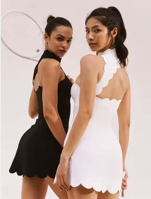Stay elegant and agile with the Wavy Scallop High Neck Backless Tennis Dress with Shorts, designed for performance and style. The high neck scallop design adds sophistication, while the backless cut ensures breathability and modern flair. The built-in shorts provide coverage and comfort, allowing full freedom of movement for tennis, golf, or other fitness activities. Made from breathable, stretchable, and moisture-wicking fabric, this tennis dress keeps you cool and confident during every match or workout. Its wavy detailing adds a feminine, stylish touch to your activewear collection. Features: High neck scallop edge for elegance Backless design for breathability and style Built-in shorts for coverage and comfort Lightweight, stretchable, and moisture-wicking fabric Ideal for tennis, golf, yoga, or athleisure Stylish 2-in-1 coordinated set